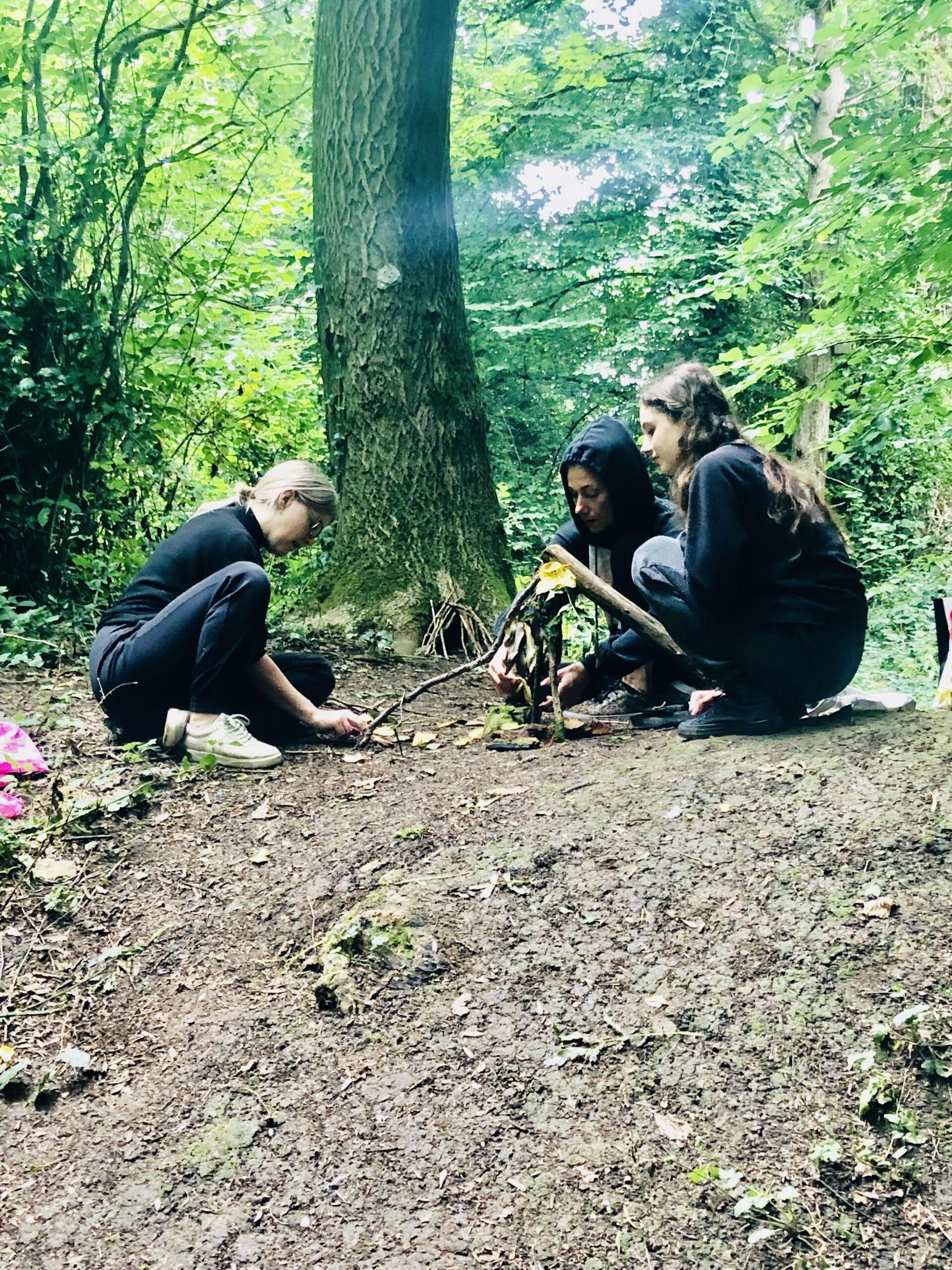 3 dancers working in the woods with a range of natural materials exploring natural sounds, and working with textures to create movement scores